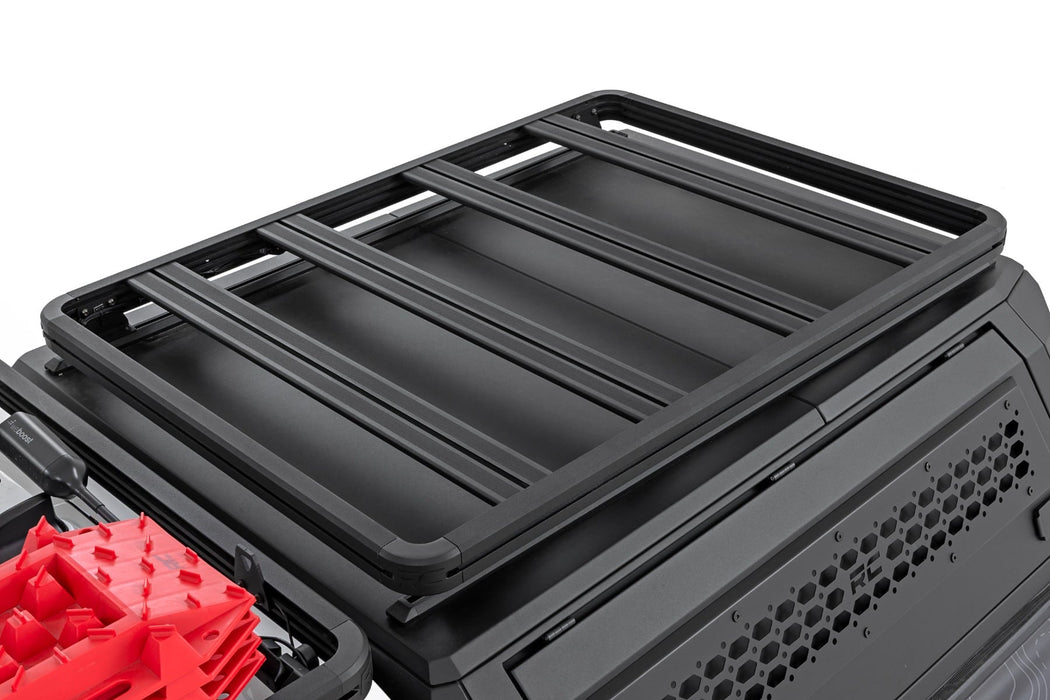 Black roof rack system on a vehicle with red cargo box