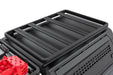 Black roof rack system on a vehicle with red cargo box